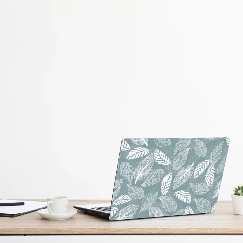 Naklejka na laptopa ręcznie rysowany wzór liści na miętowym tle