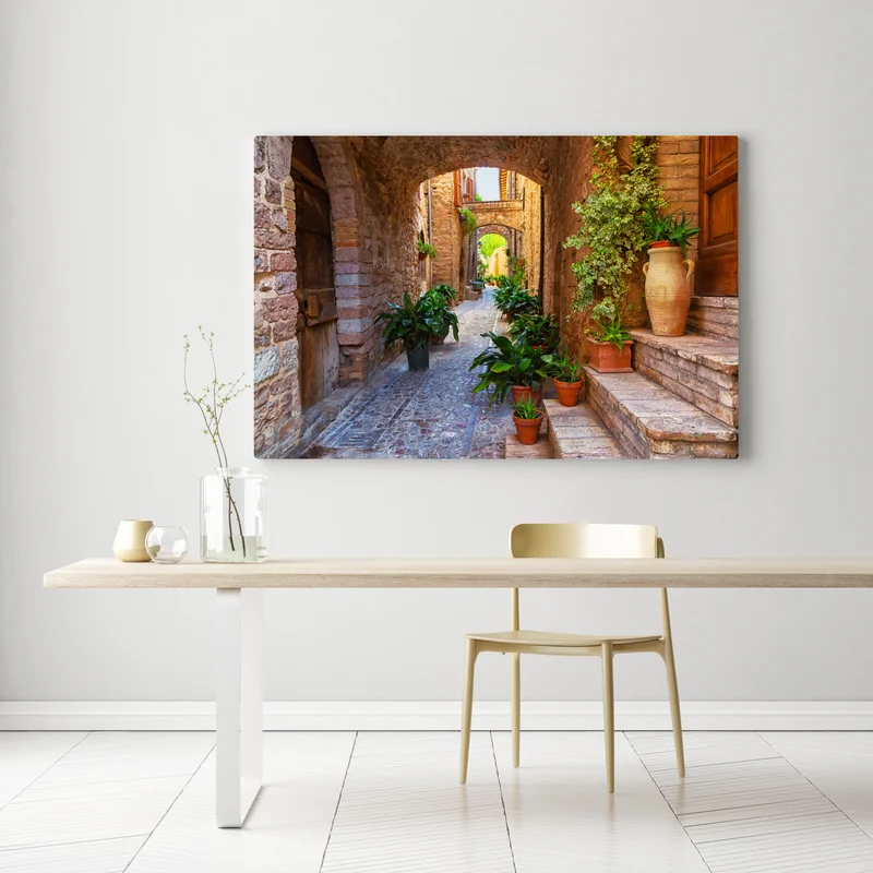 Leinwandbild sonnige gasse mit blumentöpfen in Spello Leinwandbild sonnige gasse mit blumentöpfen in Spello