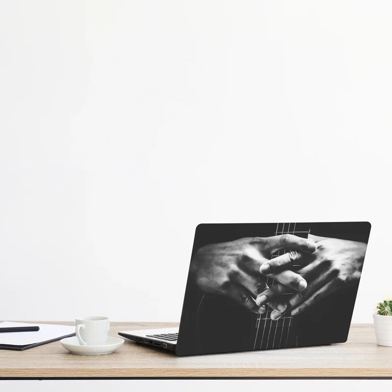 Naklejka na laptopa splątane ręce na strunach gitary