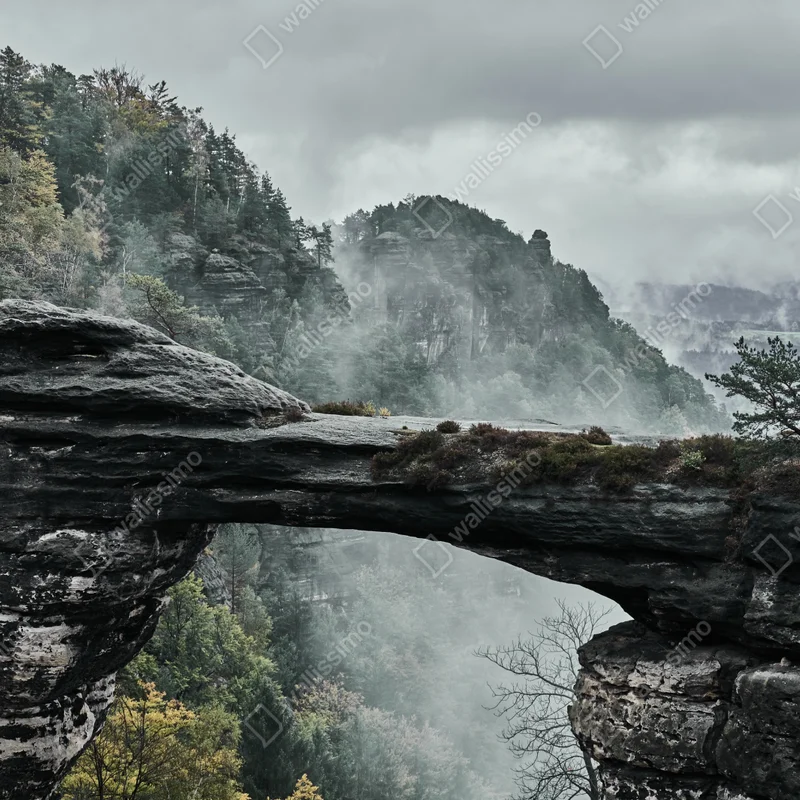 Poster nebliger felsbogen in gebirgstal • Poster bei Wallnifity® Poster nebliger felsbogen in gebirgstal • Poster bei Wallnifity®