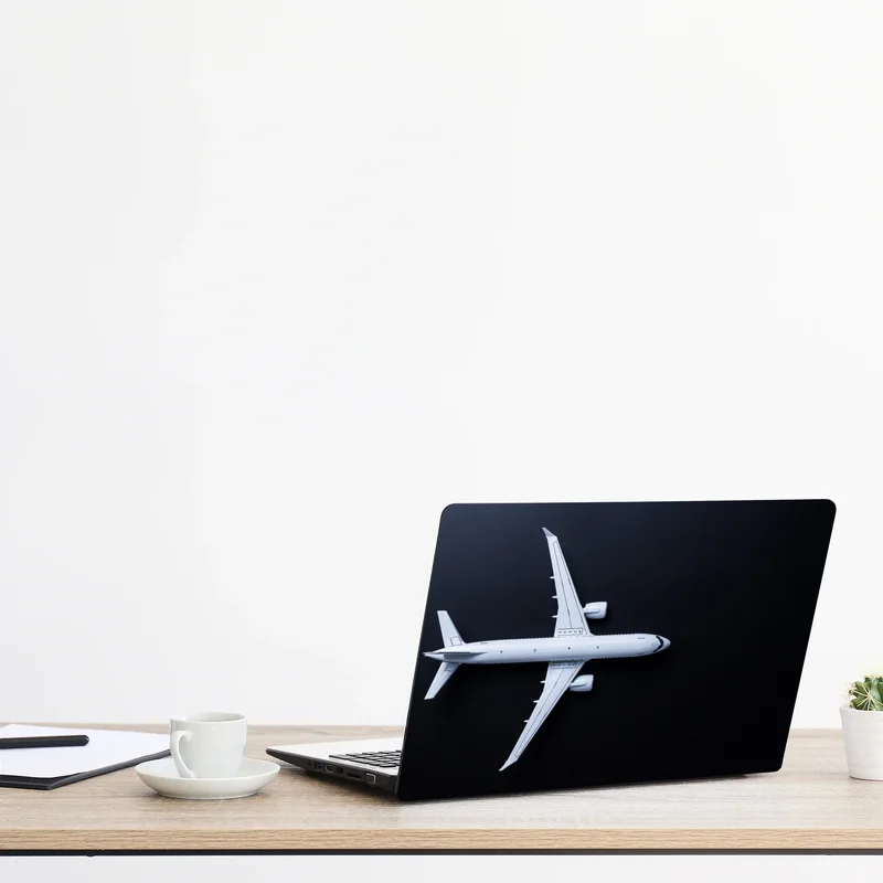 Laptop-Aufkleber weißes flugzeug von oben auf schwarzem hintergrund