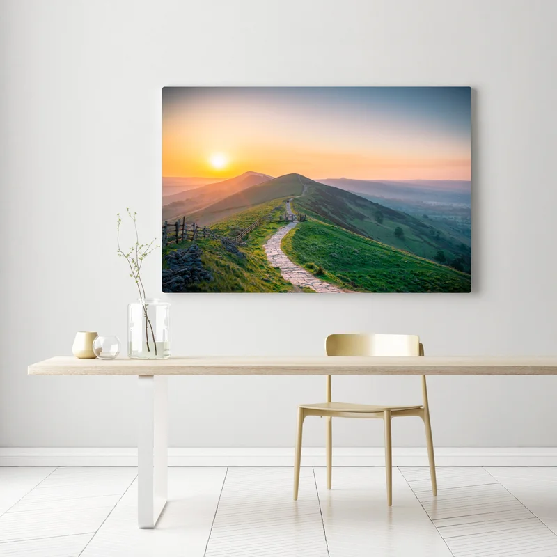 Leinwandbild sonnenaufgang über grünen hügeln mit steinweg Leinwandbild sonnenaufgang über grünen hügeln mit steinweg