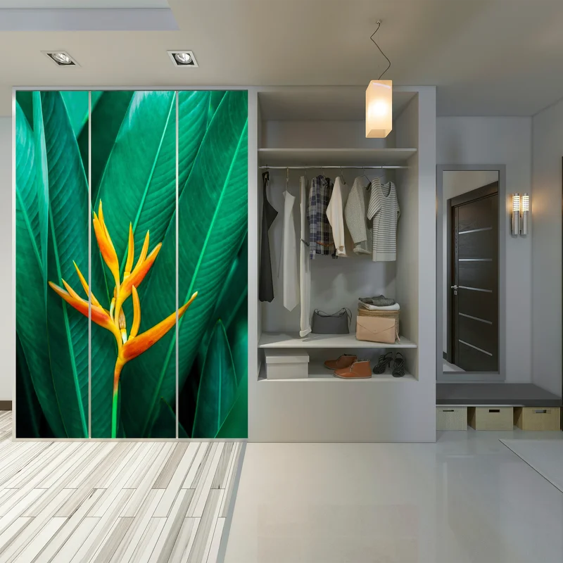 Schrankaufkleber leuchtende tropische paradiesvogelblume auf grünen blättern