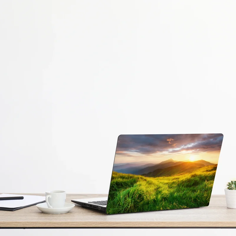 Naklejka na laptopa słoneczna górska łąka o wschodzie słońca