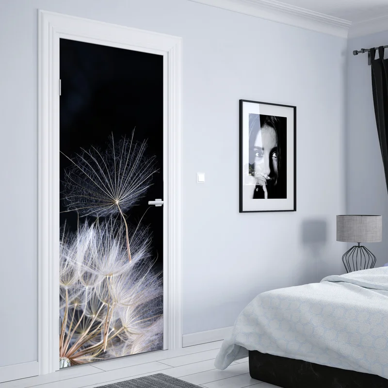 Türaufkleber zarter löwenzahnsamen auf schwarzem hintergrund